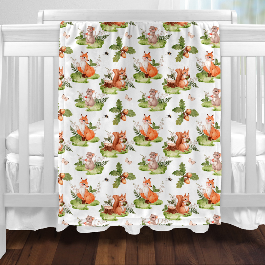 Woodland baby blanket featuring a fox, squirrel and mouse.
