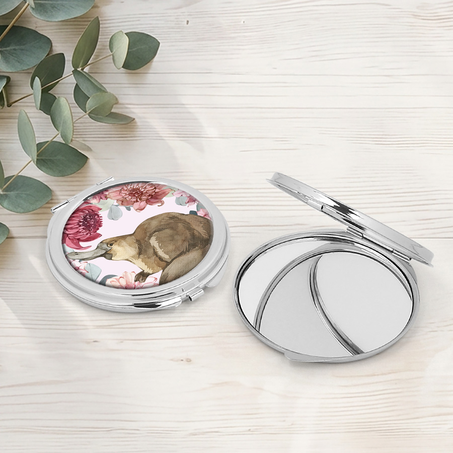 A compact mirror featuring a platypus and an open compact mirror.