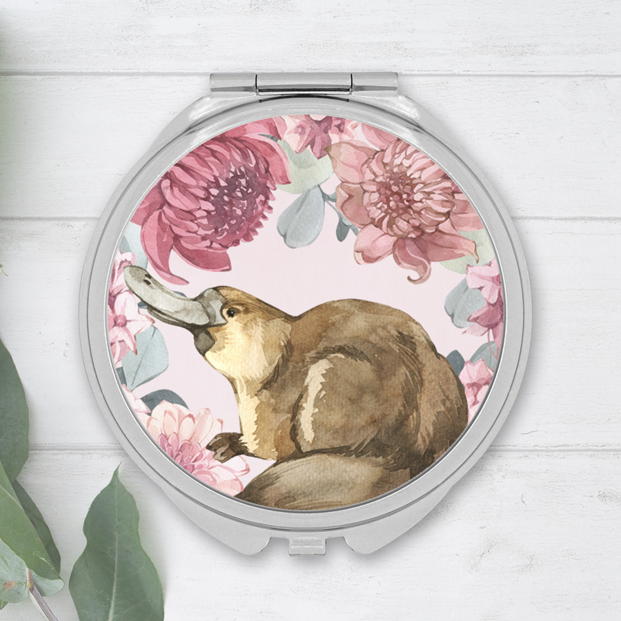 Compact mirror featuring a cute platypus and native flower design.