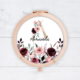 Burgundy roses with initial and name on a compact mirror.