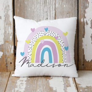 Personalised cushion with a rainbow and hearts.