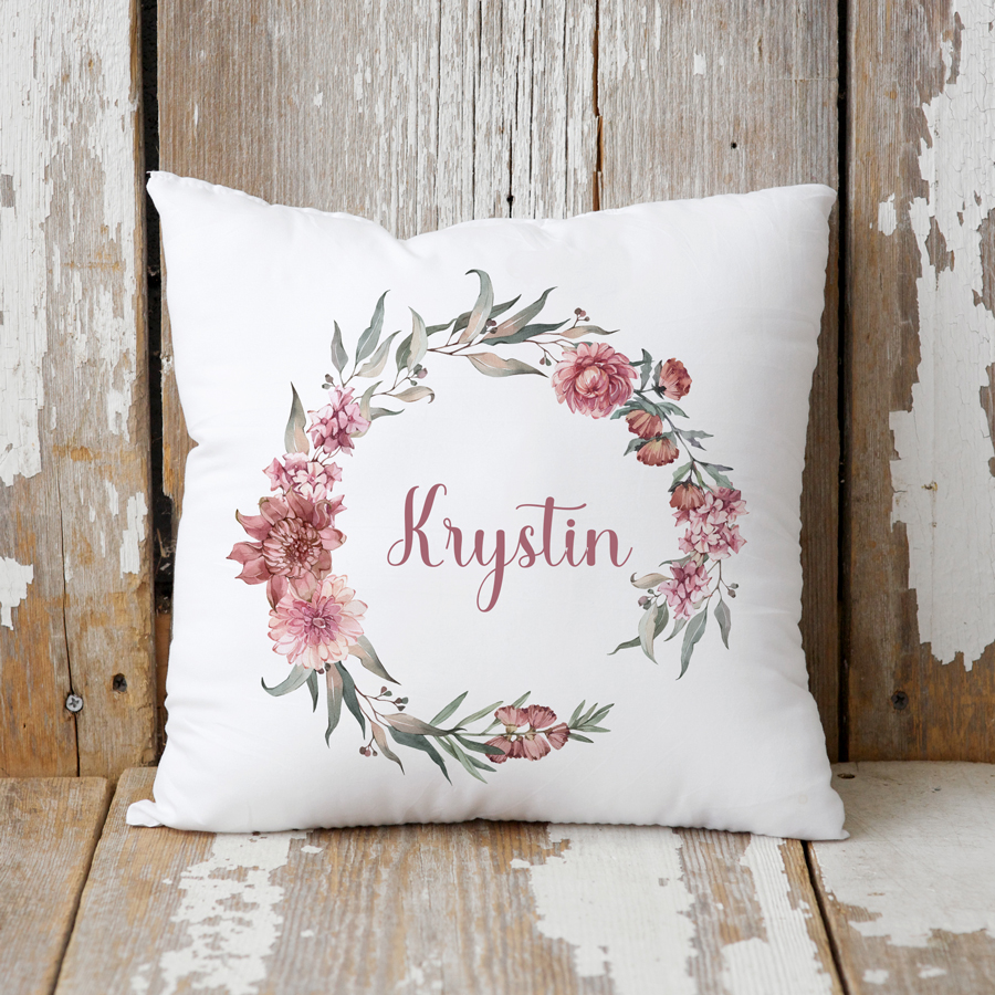 Personalised floral wreath cushion with name.