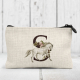 Grey horse and initial printed on a coin purse.