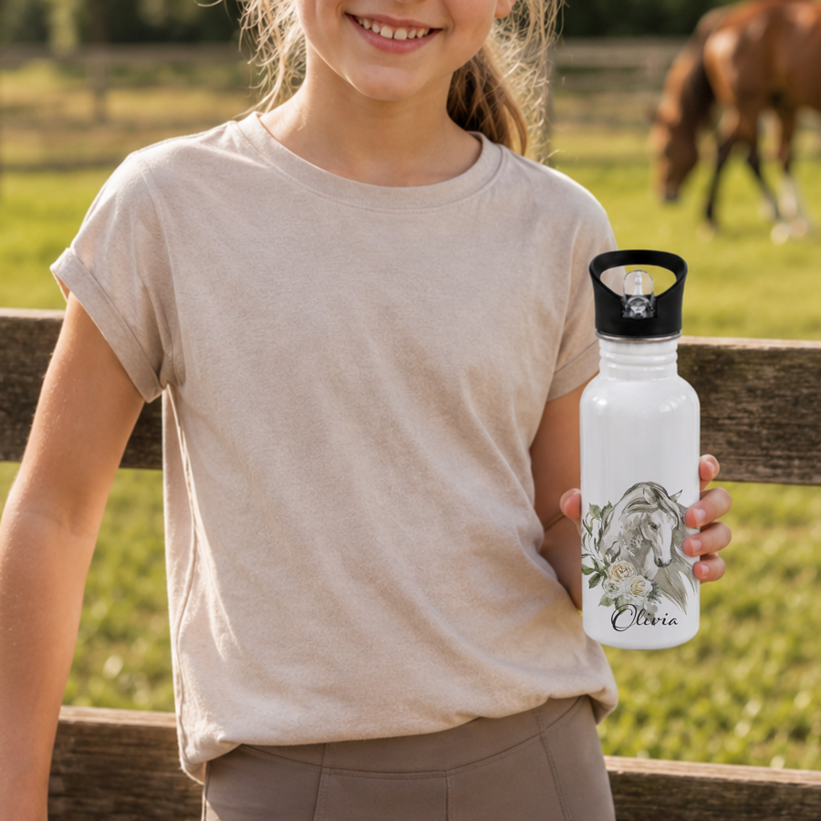 Girl holding a stainless steel drink bottle featuring a horse head and name.