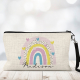 Rainbow and hearts on a personalised linen makeup bag.
