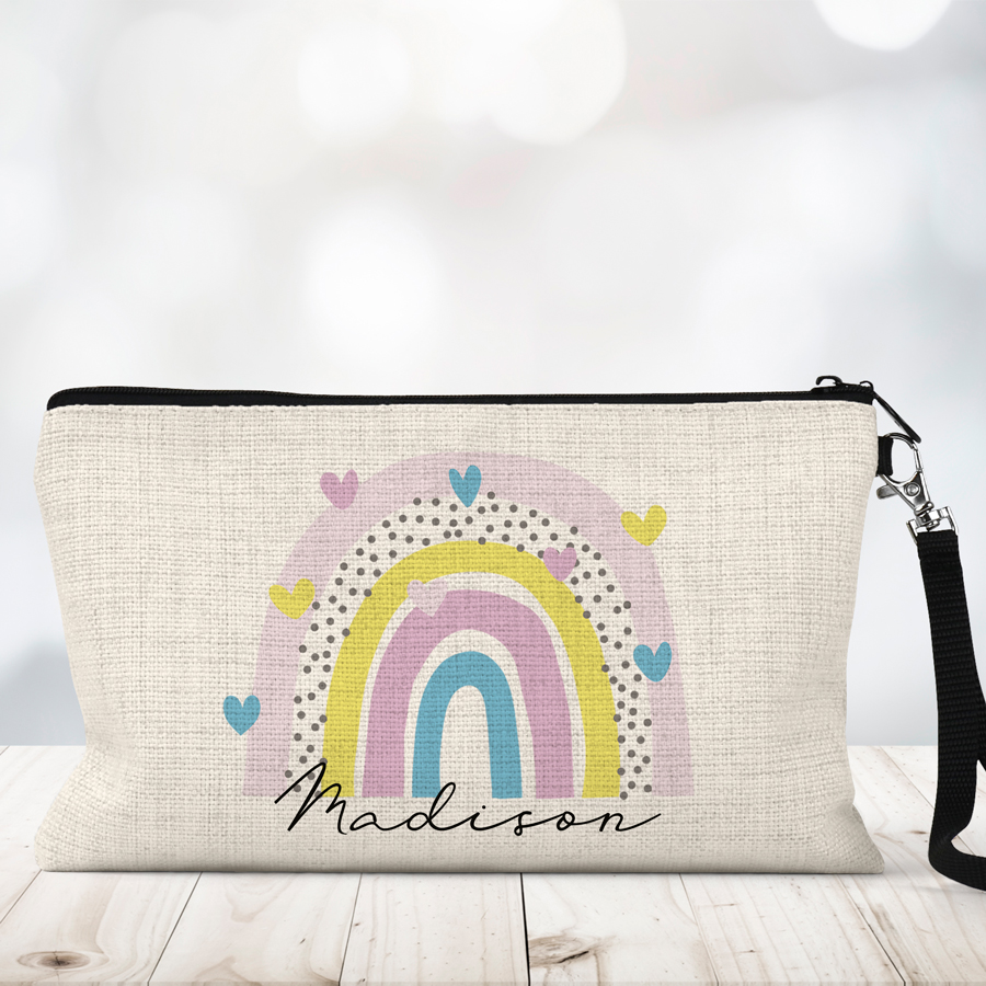 Rainbow and hearts on a personalised linen makeup bag.