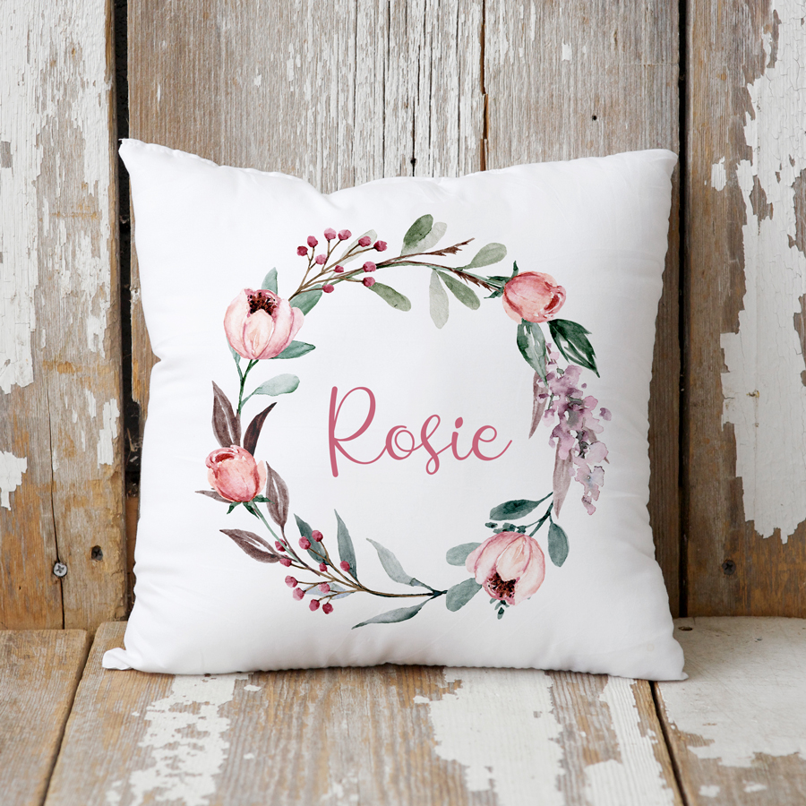 Personalised rose wreath cushion with a name.